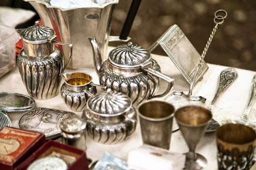 Sterling silver tea set sits awaiting to be sold.